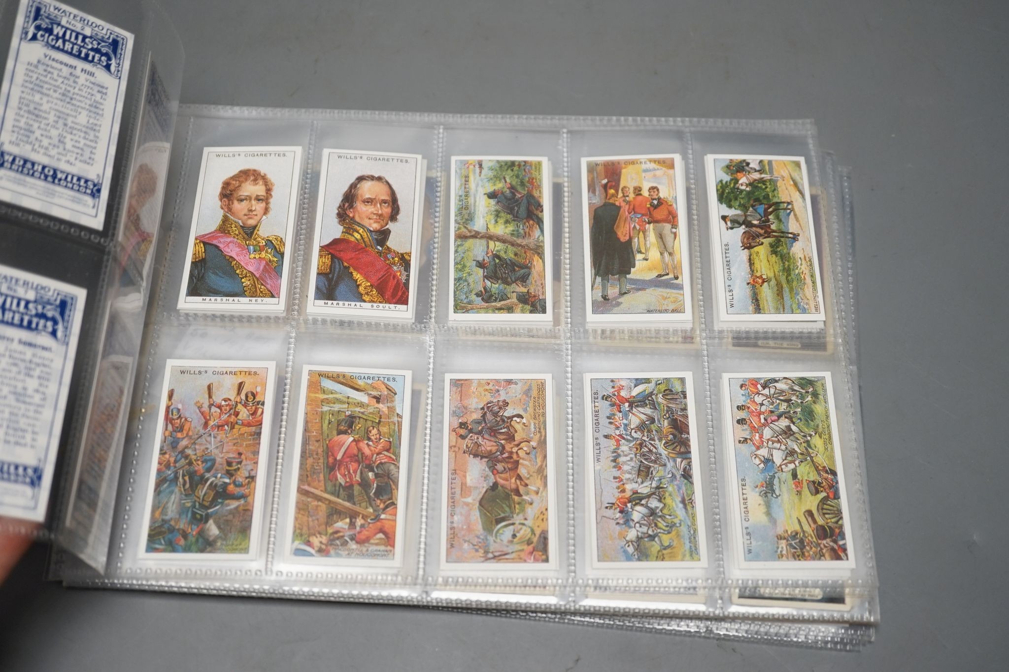 A large collection of pre and post war cigarette cards, in two albums, mounted in a plastic sheets and loose